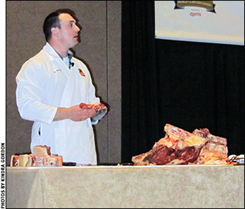 Phil Bass demonstrates meat-cutting techniques.